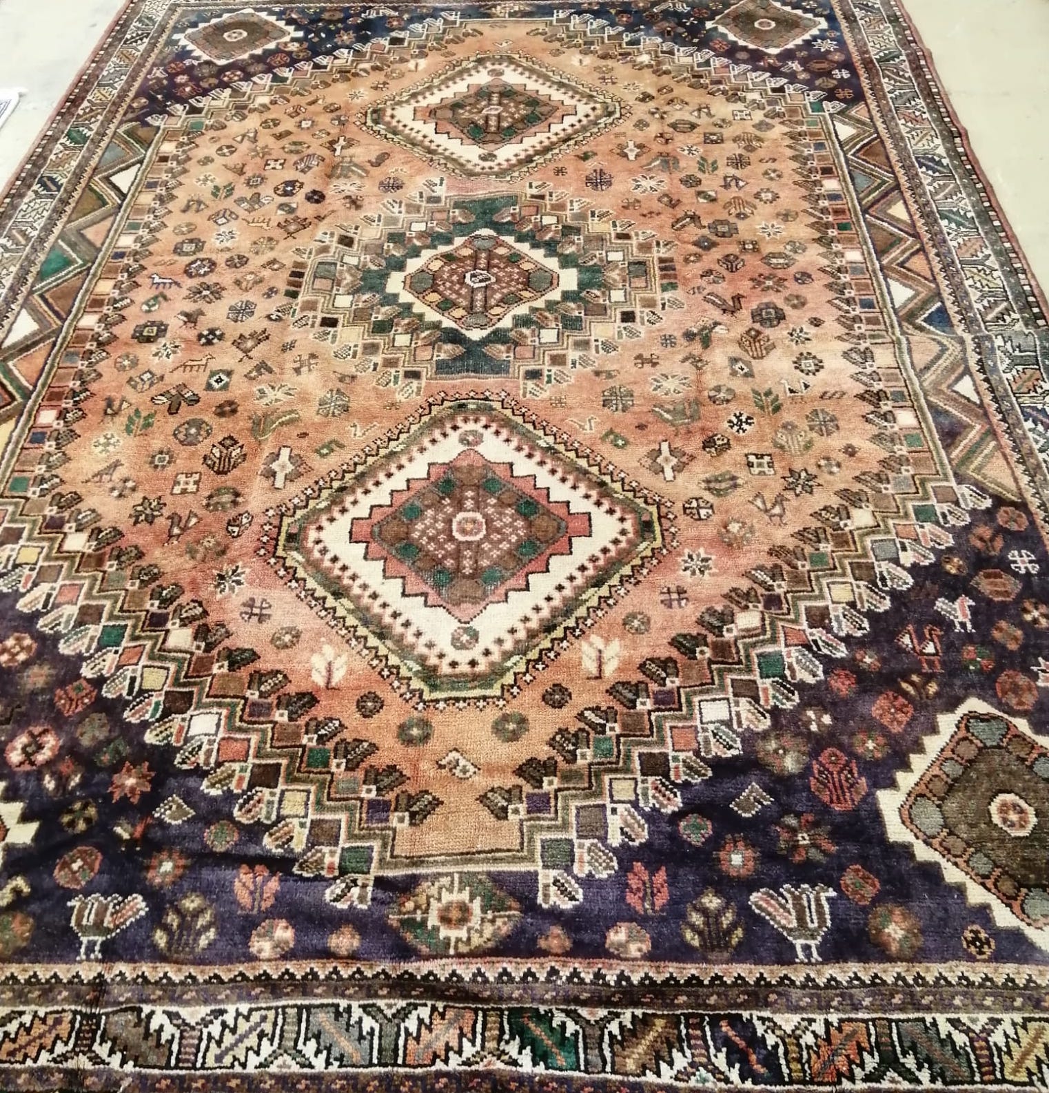 A Shiraz brick red ground carpet, 310 x 218cm